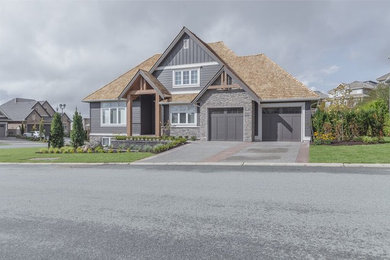 Example of a large trendy brown three-story concrete fiberboard exterior home design in Vancouver