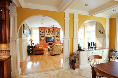 Photo of an arts and crafts living room in Portland Maine with light hardwood floors, a built-in media wall and yellow walls.