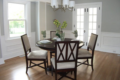 Inspiration for a timeless light wood floor enclosed dining room remodel in Philadelphia with gray walls