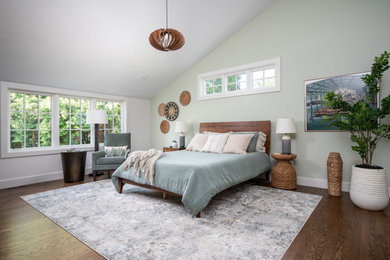Example of a mid-sized transitional master medium tone wood floor, brown floor and vaulted ceiling bedroom design in Grand Rapids with green walls
