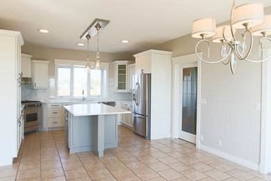 Inspiration for a mid-sized timeless u-shaped ceramic tile and beige floor eat-in kitchen remodel in Calgary with an undermount sink, recessed-panel cabinets, white cabinets, quartz countertops, white backsplash, marble backsplash, stainless steel appliances and an island