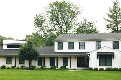 Country white two-story board and batten house exterior idea in Chicago with a shed roof, a mixed material roof and a black roof