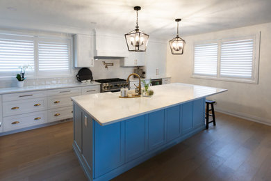 Example of a trendy light wood floor and brown floor eat-in kitchen design in Toronto with shaker cabinets, blue cabinets, quartzite countertops, white backsplash, porcelain backsplash, an island and white countertops