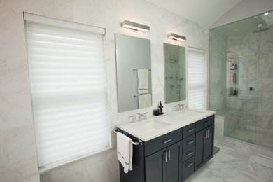 Large trendy master gray tile, white tile and stone tile marble floor alcove shower photo in Chicago with shaker cabinets, black cabinets, white walls, an undermount sink, quartzite countertops and an undermount tub