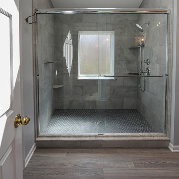 Pristine Tranquil Primary Bathroom with Free Standing Tub and Tiled Shower