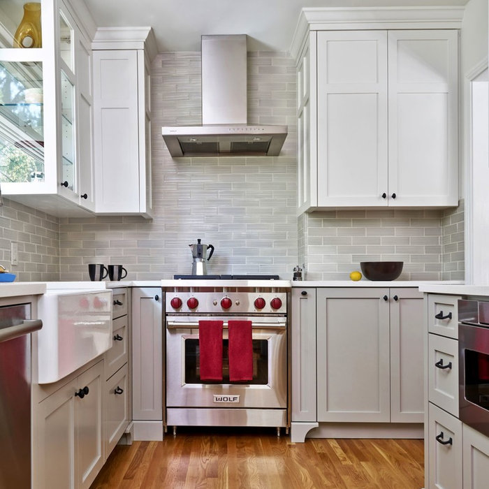 These soft gray base cabinets anchor the kitchen's color palette while the lighter upper cabinets give the room a larger feel.  The new gleaming oak flooring was installed to match the floor in the ad