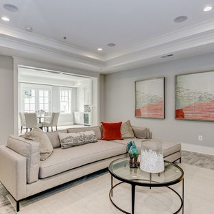 Inspiration for a large traditional walk-out basement in DC Metro with grey walls, ceramic flooring, a standard fireplace, a wooden fireplace surround and grey floors.