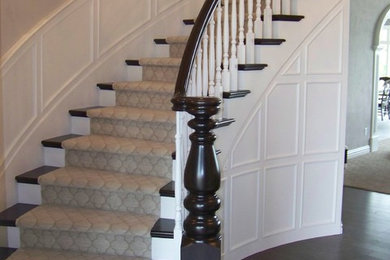 Example of a large classic wooden curved staircase design in Other with painted risers