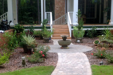 Mid-sized traditional front yard partial sun garden in Atlanta with a water feature and brick pavers.