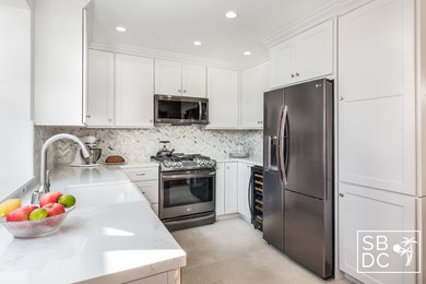 Inspiration for a mid-sized transitional u-shaped porcelain tile and beige floor kitchen pantry remodel in Los Angeles with a farmhouse sink, shaker cabinets, white cabinets, quartz countertops, white backsplash, marble backsplash, stainless steel appliances and white countertops