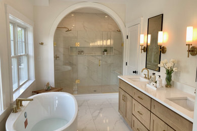 Inspiration for a large transitional master white tile and ceramic tile ceramic tile, white floor and double-sink bathroom remodel in Boston with recessed-panel cabinets, medium tone wood cabinets, white walls, an undermount sink, quartz countertops, a hinged shower door and white countertops