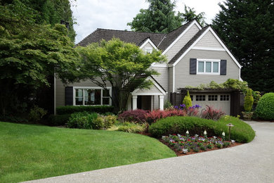 Large traditional gray two-story wood exterior home idea in Seattle