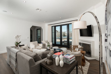 Trendy medium tone wood floor family room photo in Orlando with a wall-mounted tv