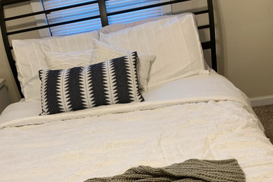 Small transitional master carpeted and beige floor bedroom photo in Burlington with beige walls