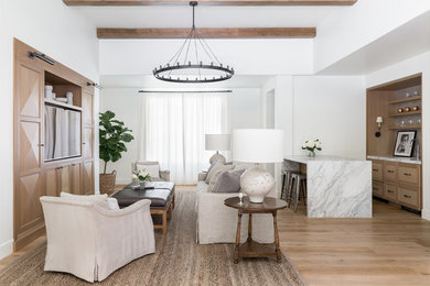 Design ideas for a transitional open concept family room in Seattle with a home bar, white walls, light hardwood floors, no fireplace and a built-in media wall.