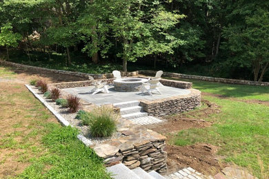Photo of a rustic backyard landscaping in Boston with a fire pit.
