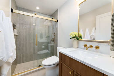 Bathroom - small modern beige tile and porcelain tile porcelain tile, white floor and single-sink bathroom idea in Chicago with recessed-panel cabinets, medium tone wood cabinets, a two-piece toilet, white walls, an undermount sink, quartz countertops, white countertops, a niche and a freestanding vanity