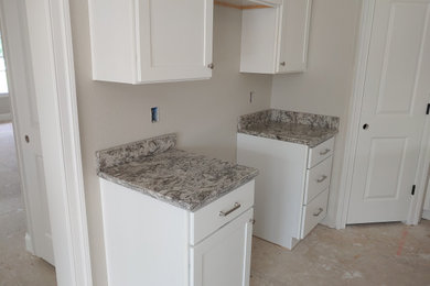 Inspiration for a large coastal beige floor kitchen remodel in Other with an undermount sink, shaker cabinets, white cabinets, quartz countertops, beige backsplash, quartz backsplash, stainless steel appliances, an island and beige countertops