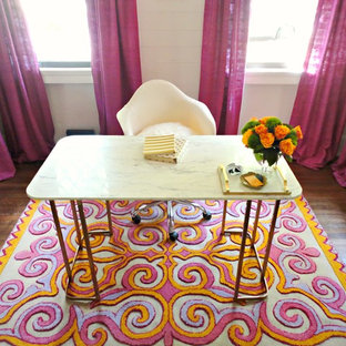 Small modern home office and library in Atlanta with white walls, medium hardwood flooring and a freestanding desk.