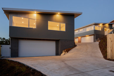 Inspiration for a large modern two-storey exterior in Hobart with a flat roof.