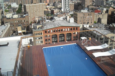 Inspiration for a mid-sized traditional rooftop rectangular lap pool in New York with decking.