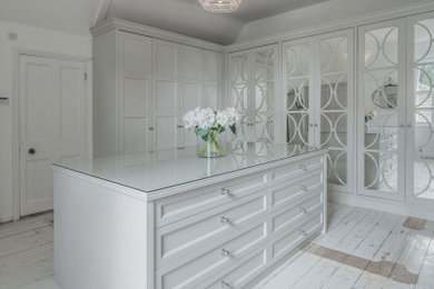 Inspiration for a modern built-in wardrobe in Hampshire with white cabinets.