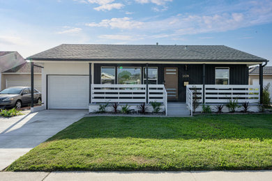 Example of a black one-story mixed siding and board and batten house exterior design in Los Angeles with a shingle roof and a gray roof