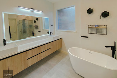 Inspiration for a mid-sized contemporary master white tile and porcelain tile ceramic tile, gray floor and double-sink bathroom remodel in Austin with flat-panel cabinets, light wood cabinets, white walls, a vessel sink, quartz countertops, a hinged shower door, white countertops, a niche and a floating vanity
