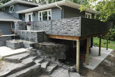 Inspiration for a large modern full sun front yard waterfall in Other for summer.