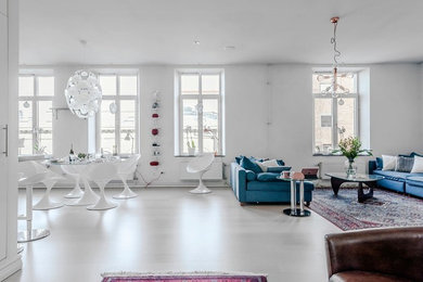 Photo of a mid-sized contemporary open concept living room in Gothenburg with white walls, no fireplace, no tv and white floor.