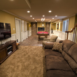 This is an example of a medium sized traditional look-out basement in Philadelphia with yellow walls and carpet.
