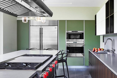 Example of a mid-sized trendy u-shaped ceramic tile enclosed kitchen design in Detroit with a double-bowl sink, flat-panel cabinets, dark wood cabinets, quartz countertops, gray backsplash, stone slab backsplash, stainless steel appliances and an island