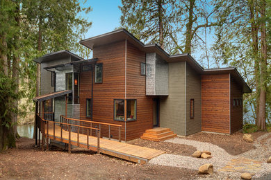 This is an example of a contemporary two-storey exterior in Other with mixed siding.