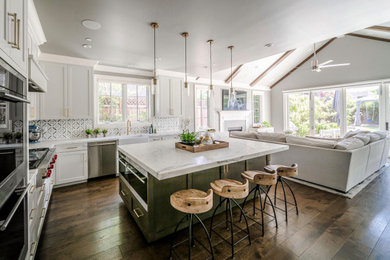 Inspiration for a contemporary l-shaped dark wood floor and brown floor open concept kitchen remodel in San Francisco with a farmhouse sink, shaker cabinets, gray cabinets, marble countertops, multicolored backsplash, mosaic tile backsplash, stainless steel appliances, an island and white countertops