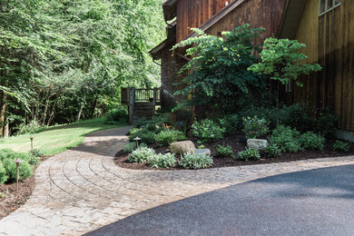 Inspiration for a mid-sized rustic partial sun front yard concrete paver garden path in New York.