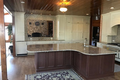Example of a transitional medium tone wood floor and brown floor kitchen design in Raleigh with an undermount sink, recessed-panel cabinets, quartz countertops, mosaic tile backsplash, an island and yellow countertops
