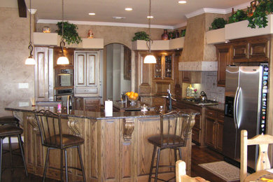 Kitchen - kitchen idea in Dallas with raised-panel cabinets and two islands