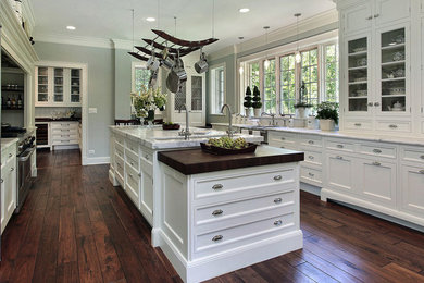 Inspiration for a large transitional u-shaped kitchen remodel in Other with recessed-panel cabinets, white cabinets and an island