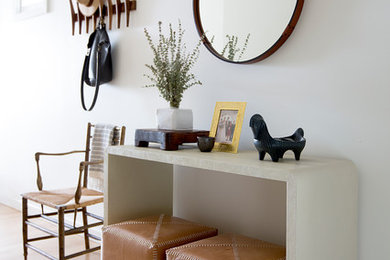 Foyer - mid-sized contemporary light wood floor foyer idea in San Francisco with white walls