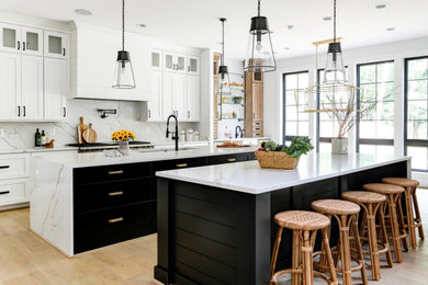 Inspiration for a mid-sized contemporary galley medium tone wood floor eat-in kitchen remodel in DC Metro with an undermount sink, shaker cabinets, white cabinets, granite countertops, white backsplash, granite backsplash, stainless steel appliances, two islands and white countertops