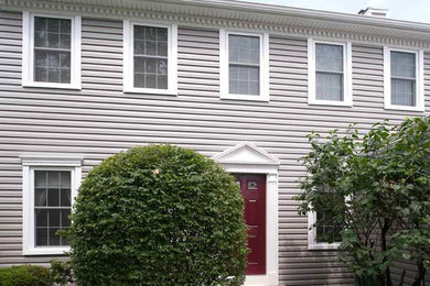 This is an example of a two-storey grey exterior in New York with vinyl siding.