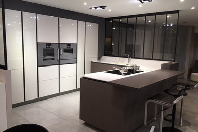 Design ideas for a medium sized contemporary u-shaped kitchen/diner in Nice with an integrated sink, recessed-panel cabinets, white cabinets, marble worktops, white splashback, marble splashback, integrated appliances, ceramic flooring, an island, grey floors and white worktops.