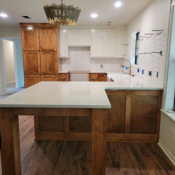 Open-Concept Two-Tone Kitchen Remodel with Seating Peninsula & Pantry Tower