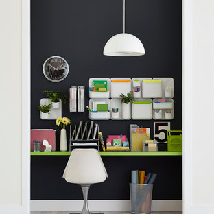 Medium sized midcentury study in Other with black walls and light hardwood flooring.