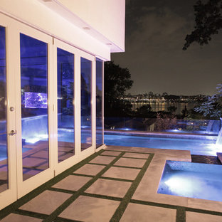 ニューヨークの大きいL型モダンスタイルのおしゃれなプール (噴水、コンクリート板舗装	) の写真