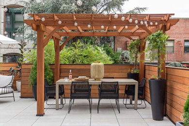 Inspiration for a contemporary shade rooftop concrete paver landscaping in New York for summer.