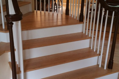 Example of a mid-sized transitional wooden curved wood railing staircase design in Boston with wooden risers