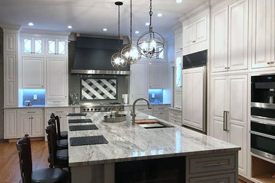 Example of a classic kitchen pantry design in New York with granite countertops and an island