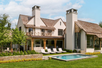 Transitional beige two-story brick house exterior idea in Philadelphia with a shingle roof