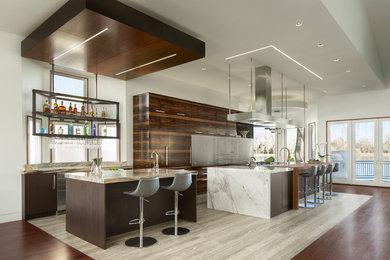 Example of a large trendy galley porcelain tile and beige floor open concept kitchen design in Other with a farmhouse sink, flat-panel cabinets, dark wood cabinets, paneled appliances, two islands, marble countertops and white countertops